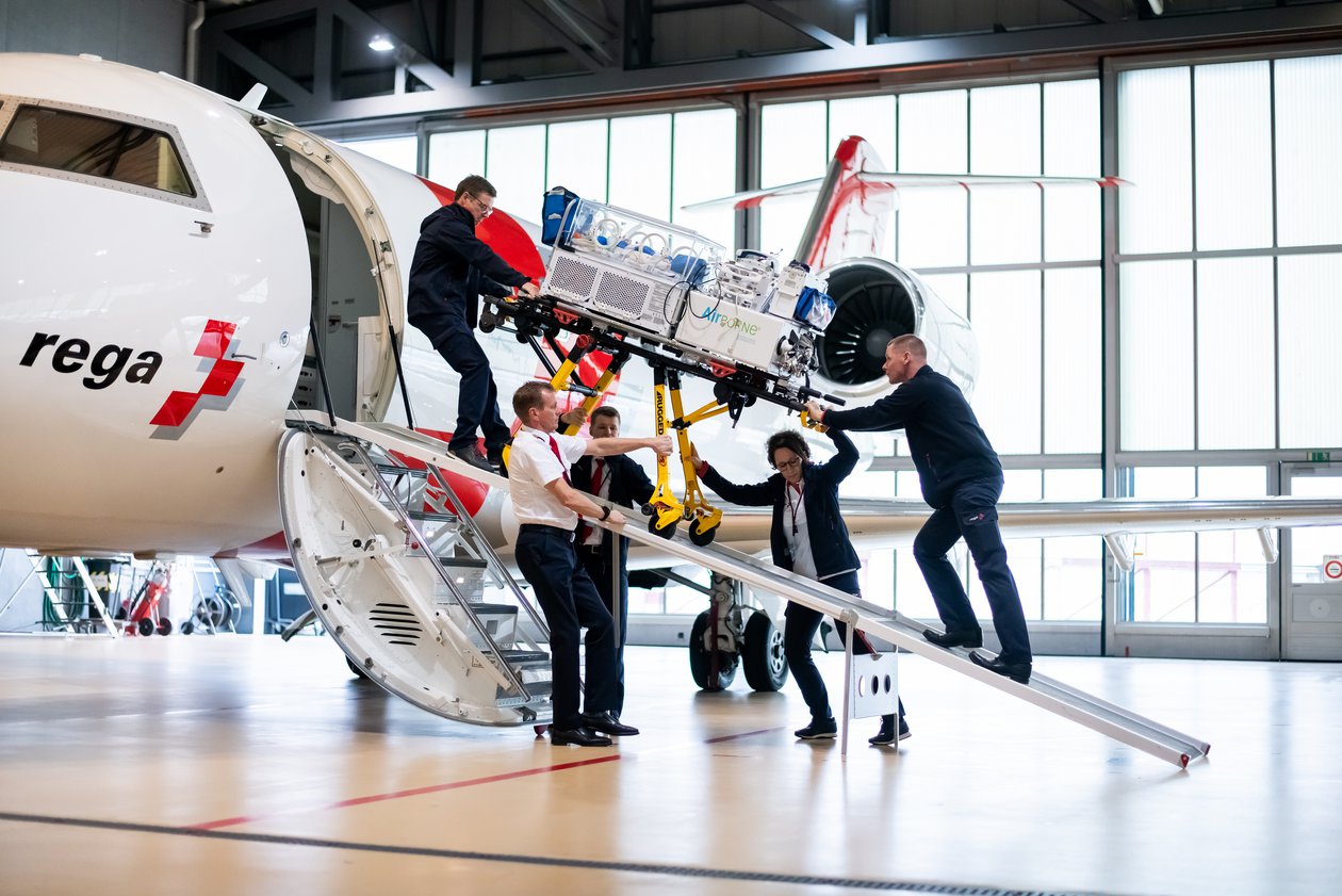 Patient on stretcher being disembarked via the foldable ramp