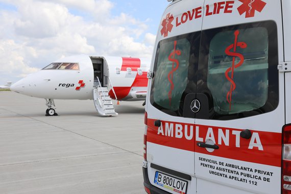 Ground ambulance in front of Swiss Air-Ambulance jet